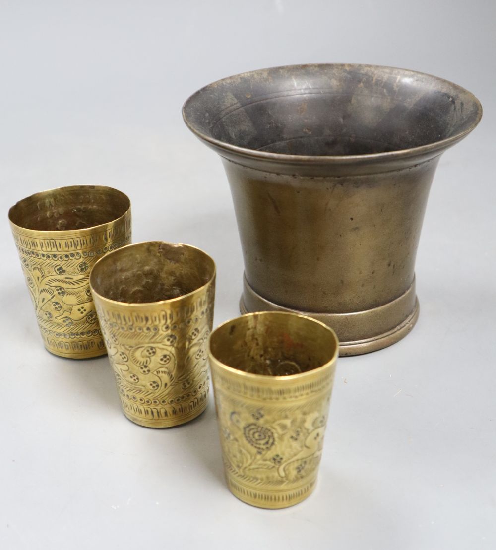 A 19th century bronze mortar and three small Persian measures